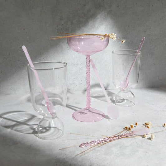 pink coupe glass stirring spoons clear cups